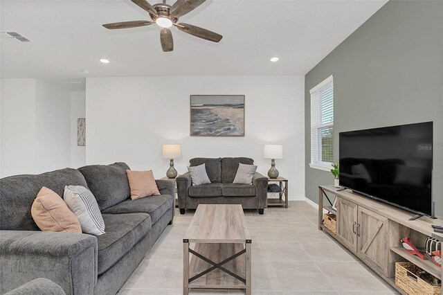 living room with ceiling fan and light tile patterned flooring