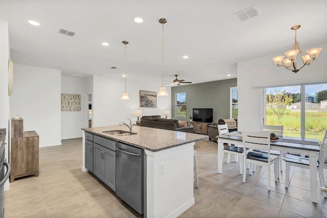 kitchen featuring sink, dishwasher, stone countertops, a center island with sink, and ceiling fan with notable chandelier