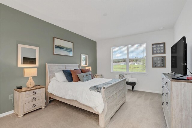 bedroom featuring light colored carpet