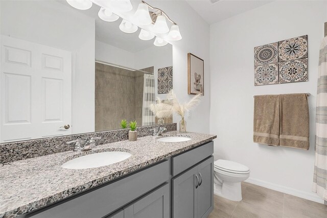 bathroom featuring toilet, vanity, tile patterned floors, and curtained shower