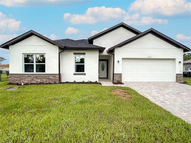 view of front facade with a garage and a front lawn