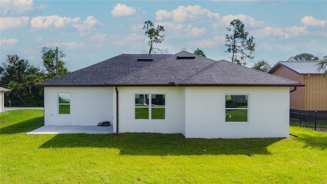 back of property featuring a lawn and a patio area