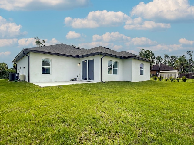 rear view of property featuring a patio, a yard, and central air condition unit