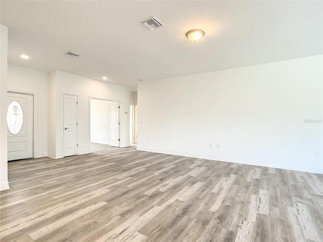 unfurnished living room featuring light wood-type flooring