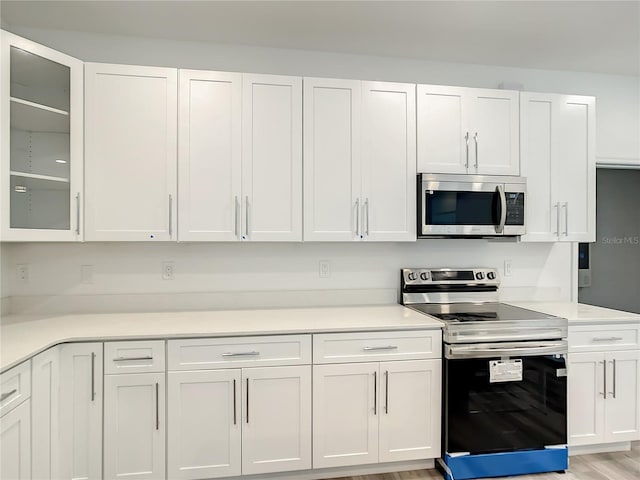 kitchen featuring white cabinetry, appliances with stainless steel finishes, and light hardwood / wood-style floors