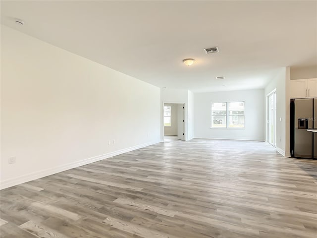 unfurnished living room with light hardwood / wood-style floors