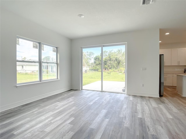 unfurnished living room with light wood-type flooring