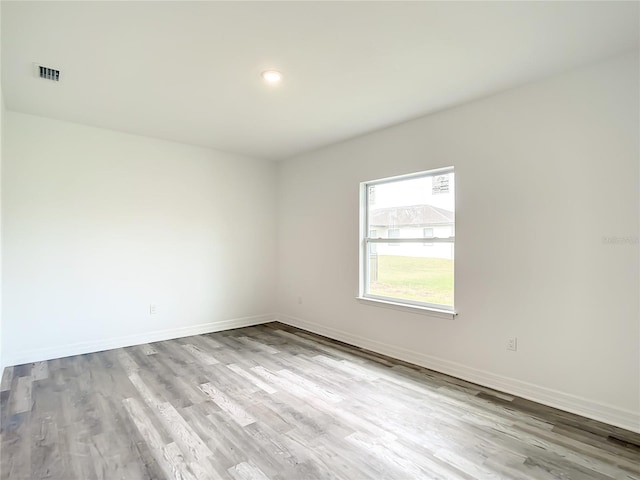 spare room featuring light hardwood / wood-style floors