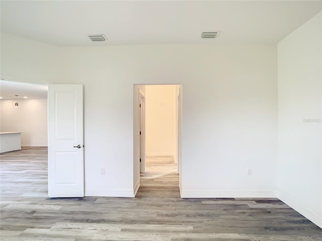 unfurnished room featuring light hardwood / wood-style floors