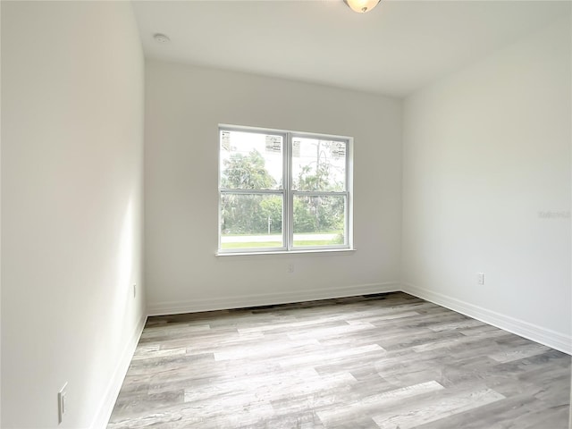 unfurnished room with light hardwood / wood-style flooring