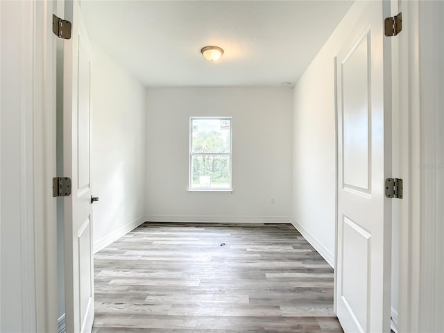 unfurnished room with light hardwood / wood-style flooring