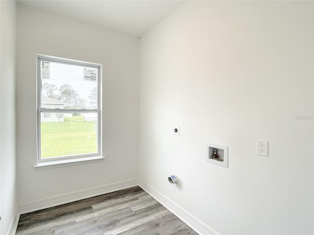 laundry area featuring washer hookup, light hardwood / wood-style floors, and hookup for an electric dryer