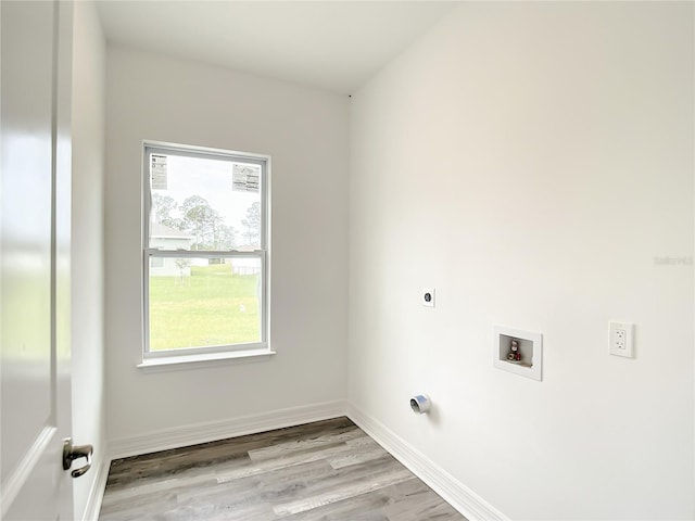 clothes washing area with light hardwood / wood-style flooring, electric dryer hookup, and hookup for a washing machine