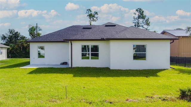 rear view of house with a yard and a patio area