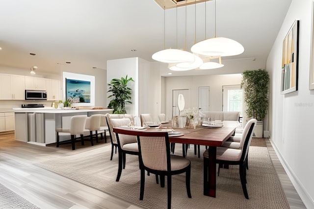 dining space featuring light hardwood / wood-style floors