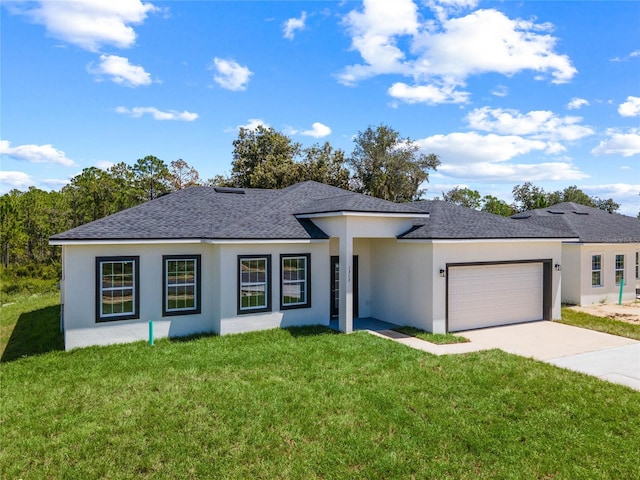 view of front of property featuring a front lawn and a garage