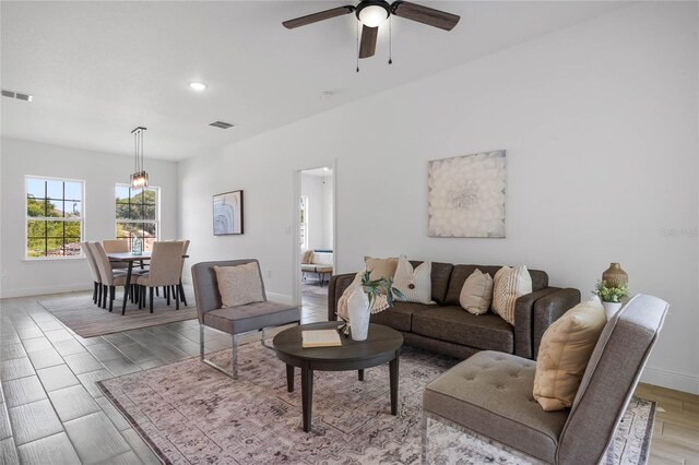 living room featuring ceiling fan and light hardwood / wood-style floors