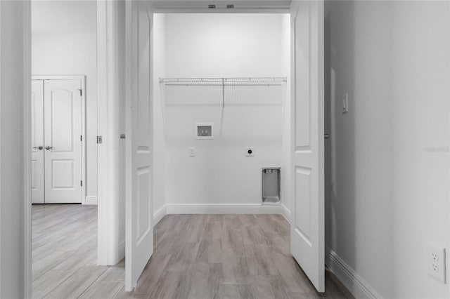 washroom featuring washer hookup, hookup for an electric dryer, and light hardwood / wood-style floors