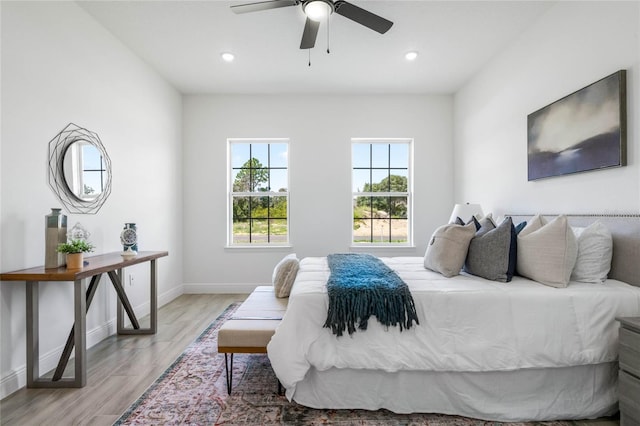 bedroom with ceiling fan and light hardwood / wood-style flooring