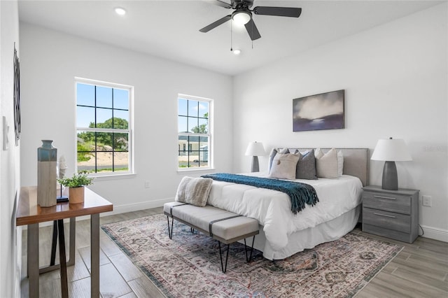 bedroom with ceiling fan and light hardwood / wood-style flooring