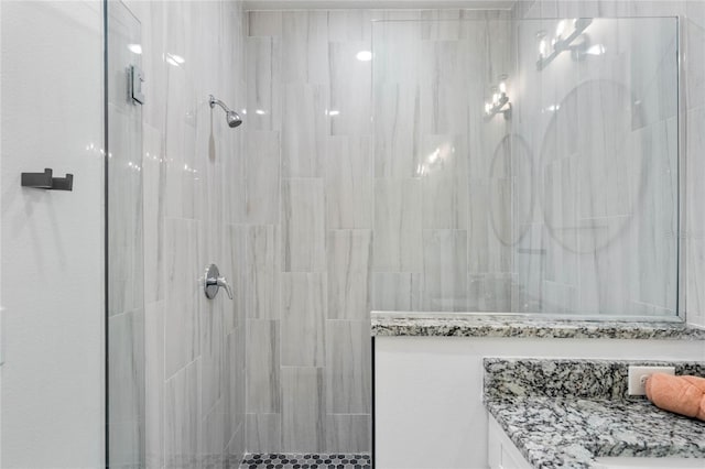 bathroom featuring vanity and a tile shower