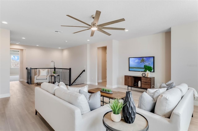 living room with ceiling fan and light wood-type flooring