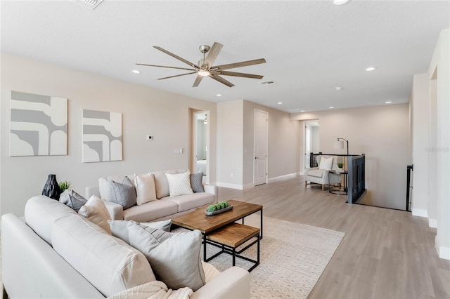 living room with ceiling fan and light hardwood / wood-style floors