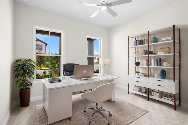 carpeted office featuring ceiling fan