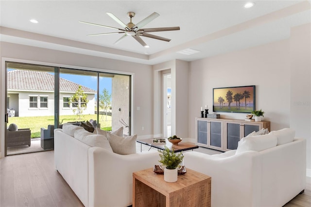 living room with ceiling fan and light hardwood / wood-style floors