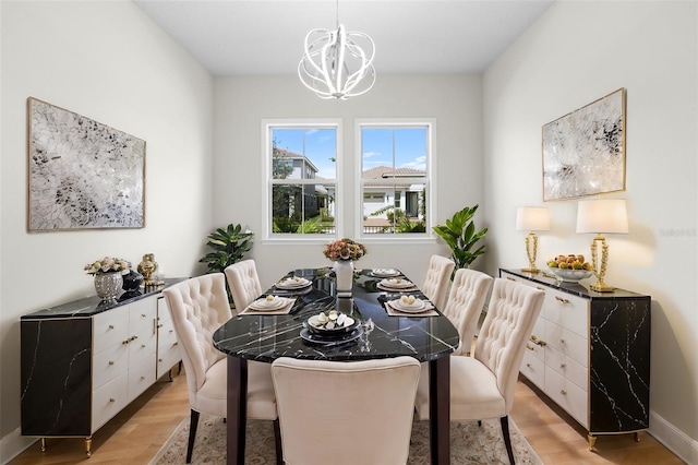 dining space featuring an inviting chandelier and light hardwood / wood-style floors