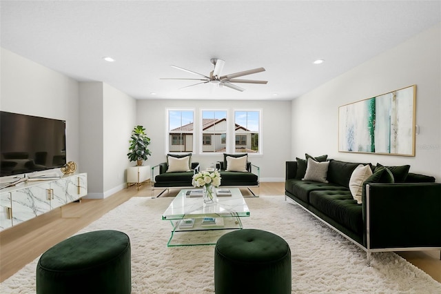 living room with light wood-type flooring and ceiling fan