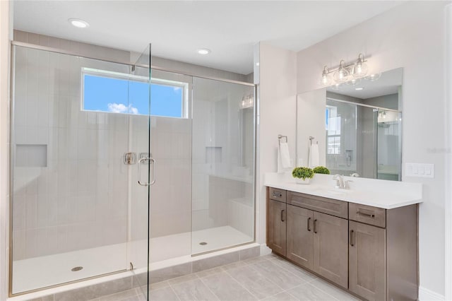 bathroom with vanity, a shower with shower door, and tile patterned floors