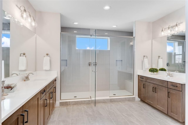 bathroom featuring an enclosed shower and vanity