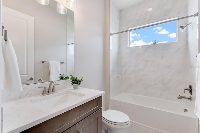 full bathroom featuring vanity, toilet, and tiled shower / bath