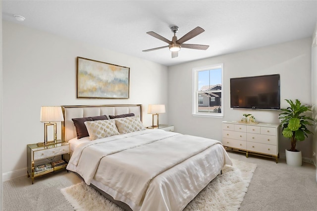 bedroom with ceiling fan and light carpet