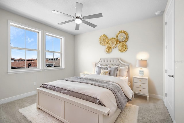 bedroom featuring ceiling fan and light colored carpet