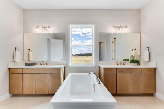 bathroom with a tub, tile patterned flooring, and vanity