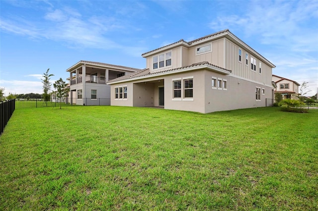 rear view of property with a lawn