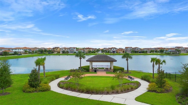 view of home's community with a water view, a yard, and a gazebo