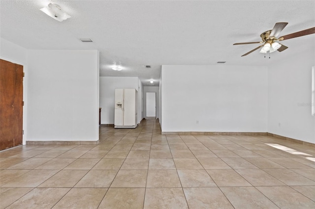 unfurnished living room with light tile patterned floors, ceiling fan, a textured ceiling, and visible vents