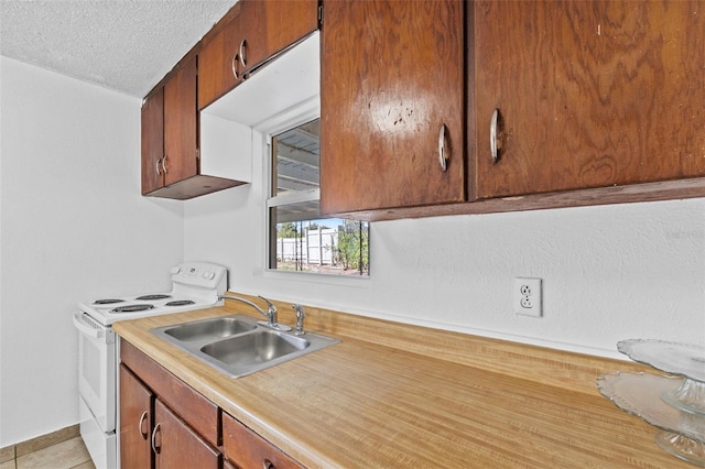 kitchen featuring white electric stove, light countertops, a textured ceiling, a sink, and light tile patterned flooring