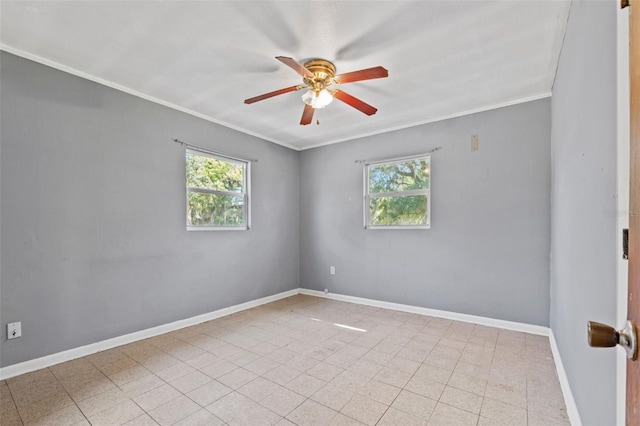 unfurnished room with plenty of natural light, baseboards, and crown molding