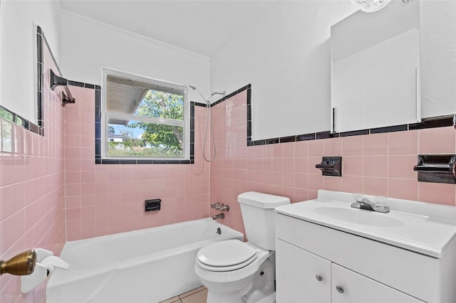 bathroom featuring toilet, shower / bath combination, vanity, tile walls, and ornamental molding