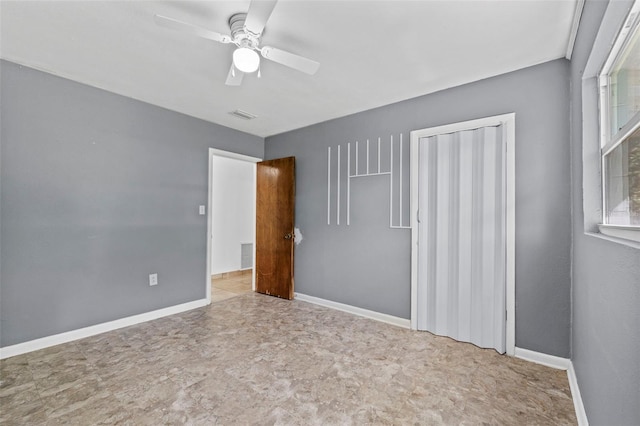 unfurnished bedroom featuring ceiling fan, a closet, visible vents, and baseboards