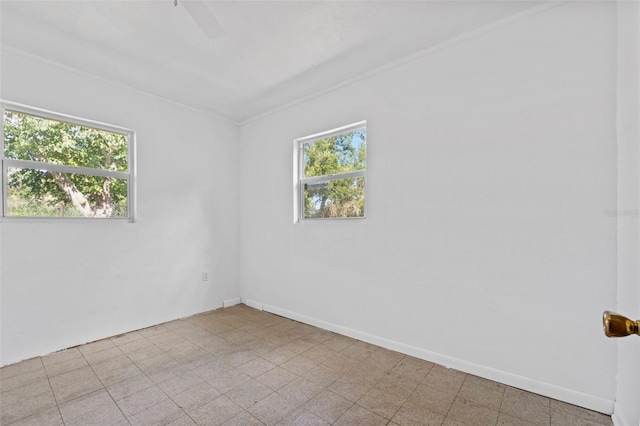 empty room featuring baseboards, a healthy amount of sunlight, and light floors