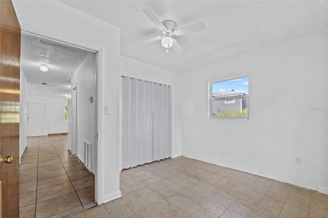 unfurnished bedroom with ceiling fan, visible vents, and a closet