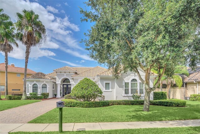 mediterranean / spanish house featuring a front yard