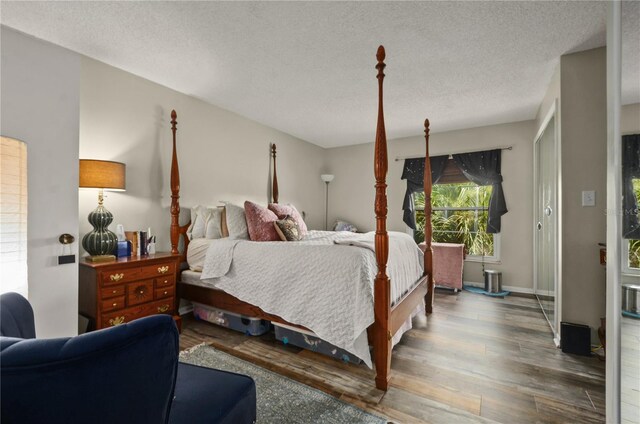 bedroom featuring hardwood / wood-style floors and a textured ceiling