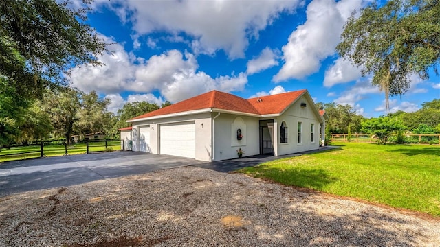 view of side of home with a lawn and a garage