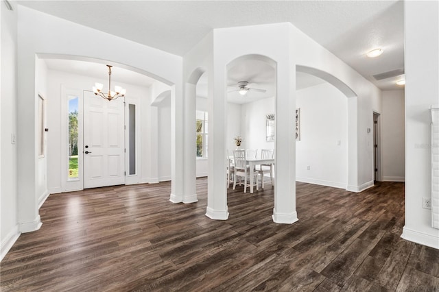 entryway with a textured ceiling, dark hardwood / wood-style floors, and ceiling fan with notable chandelier